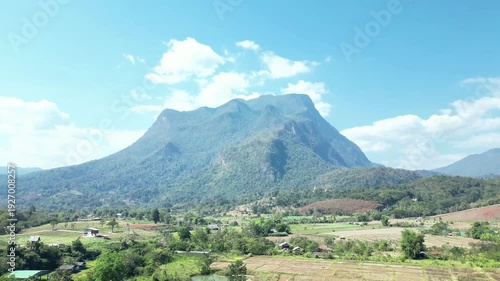 Drone Pullback at Doi Luang Chiang Dao Mountain with Camera Tilt Down Revealing Countryside, Thailand