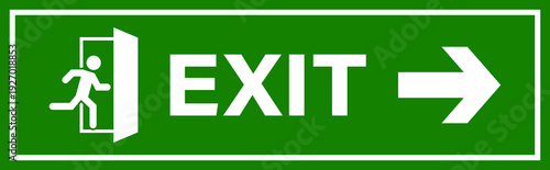 A clear green exit sign with white lettering and a running person icon indicating the direction to leave