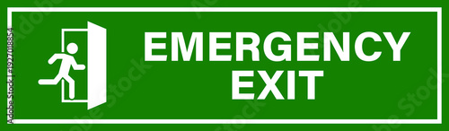 A green and white emergency exit sign with a running person icon indicating a safe escape route during an emergency