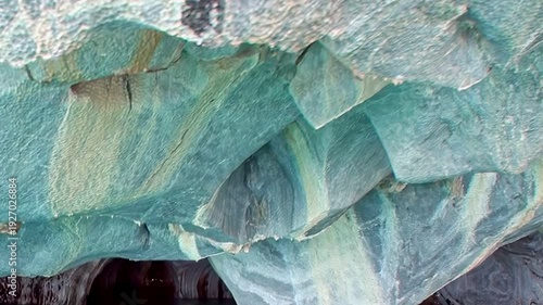 Marvel at vibrant hues within Patagonia's Marble Caves. Incredible azure and white rock formations, sculpted by nature, create artistic mosaic above clear waters. Unforgettable natural spectacle.