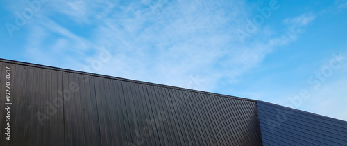 Foto Metal sheet roof curve on blue sky