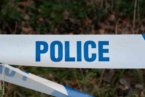 Police tape cordoning off area. Crime scene concept
