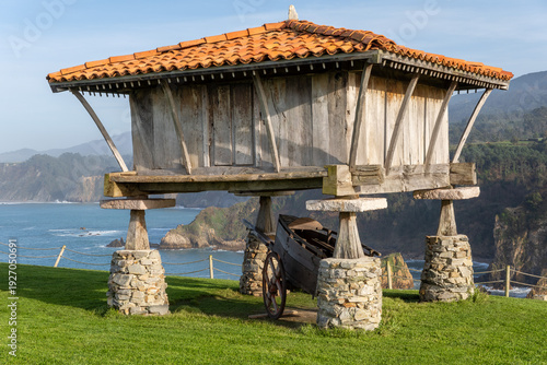 Photos A stunning landscape featuring a traditional wooden hórreo (granary) on stone pi