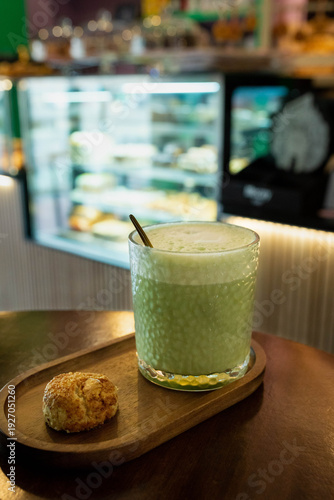 Matcha latte and scone served on wooden tray