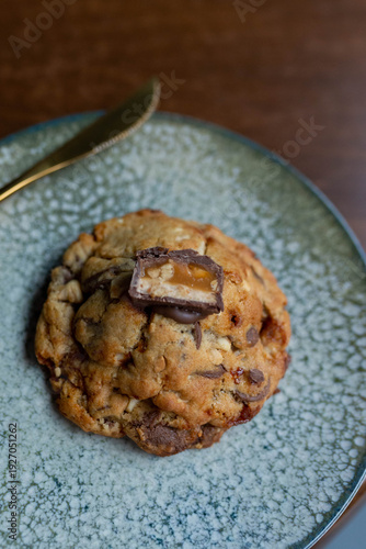 Delicious chocolate caramel cookie on a speckled plate