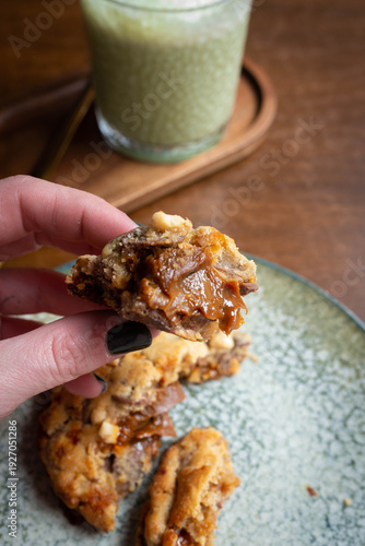 Hand holding cookie with gooey caramel filling