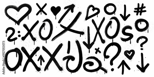 Black spray paint graffiti with hearts arrows and various symbols