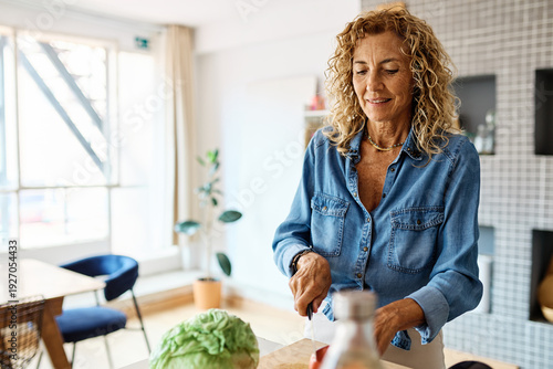Wallpaper Mural Portrait of happy senior mid aged mature couple prepering meal with fresh vegatebles in kitchen at hpme Torontodigital.ca