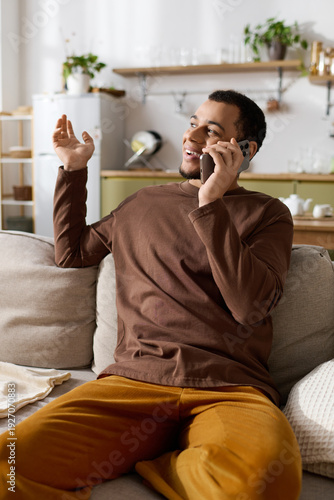 Handsome young man enjoying a cozy conversation at home on a relaxed afternoon