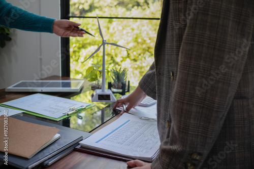 A sales representative presenting solar and wind power, alternative energy, clean energy for future.