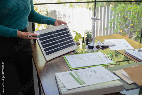 A sales representative presenting solar and wind power, alternative energy, clean energy for future.