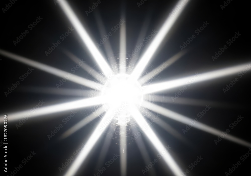 Obraz premium A bright white light with rays on a black background