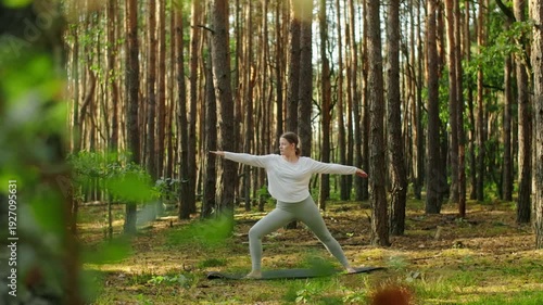 Woman meditates, relaxes and make yoga exercises in the woods alone