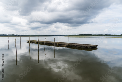 Wallpaper Mural Lake of Soustons reflecting a cloudy sky and wooden docks Torontodigital.ca