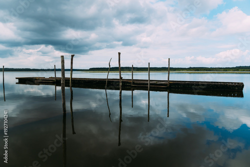 Wallpaper Mural Lake of Soustons reflecting a cloudy sky and wooden docks Torontodigital.ca