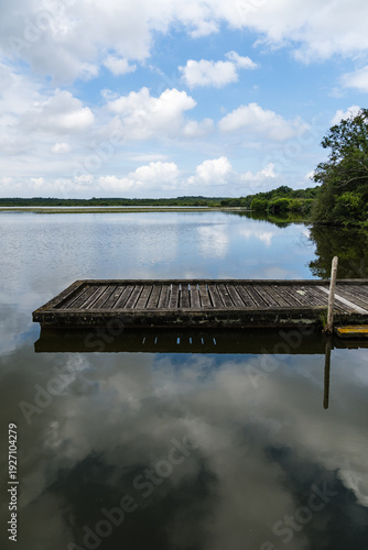 Wallpaper Mural Lake of Soustons reflecting a cloudy sky and wooden docks Torontodigital.ca