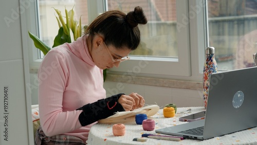 Photography Focused hobbyist meticulously making intricate embroidery stitches
