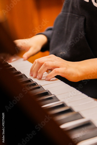 Close-up of a music performer's hand playing the piano. selective focus