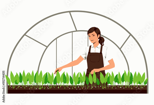 Woman tending to young green plants in a greenhouse environment, observing growth and ensuring optimal care for healthy development