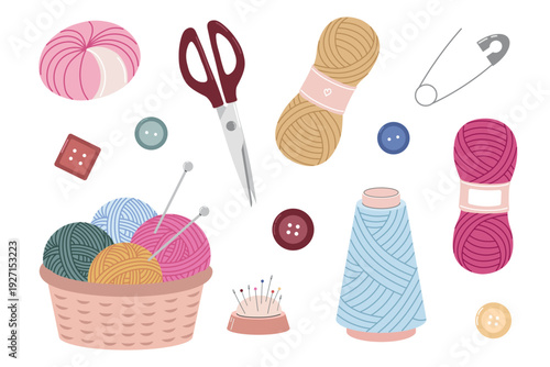 Set of knitting and sewing supplies including yarn balls, skeins, scissors, safety pin, buttons, thread spool, pincushion and knitting needles in basket