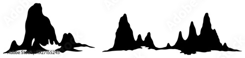 Black silhouettes of jagged mountain peaks and sharp coastal rock formations