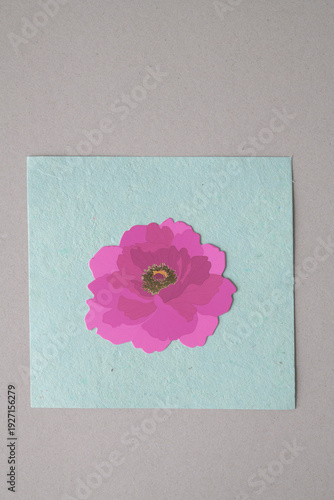 lovely pink flower die-cut from card stock on a textured paper square and millboard