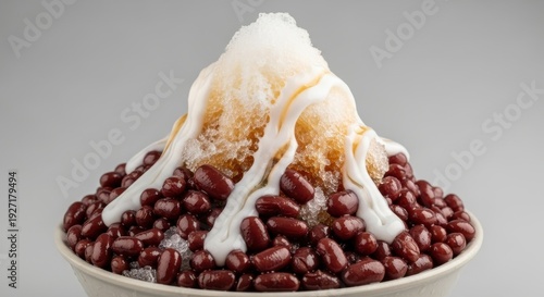 A delicious bowl of shaved ice dessert topped with red beans and milk, a refreshing treat perfect for hot weather