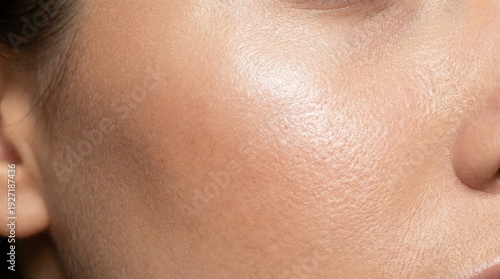 Closeup of human skin texture showing pores, oiliness, and fine lines on cheek
