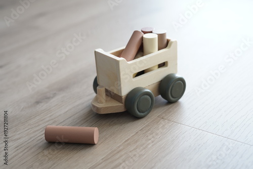 Wooden children's toy. Cart with logs.