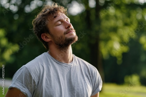 Man Takes Deep Breath Outdoors in Park After Stressful Day to Reset Mind and Body in Natural Setting