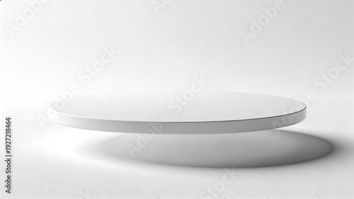 Round white display pedestal with a smooth surface and soft shadow, positioned against a minimalistic light gray background for product showcasing or presentation purposes