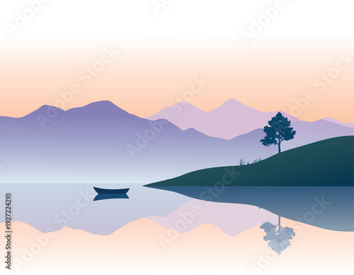Mountain landscape with foggy hills at sunrise over a lake