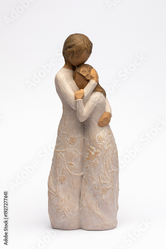 Ceramic figurine of mother and daughter on a white background