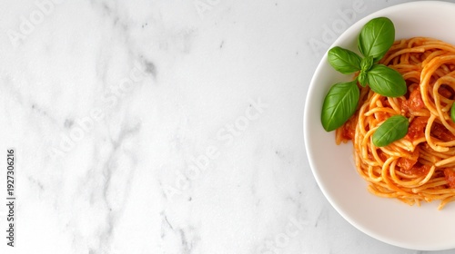 Minimalist white plate with beautifully styled spaghetti dish, top-down composition, clean aesthetic design