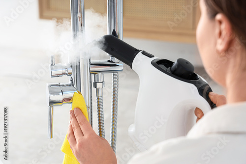 Woman steam cleaning shower...