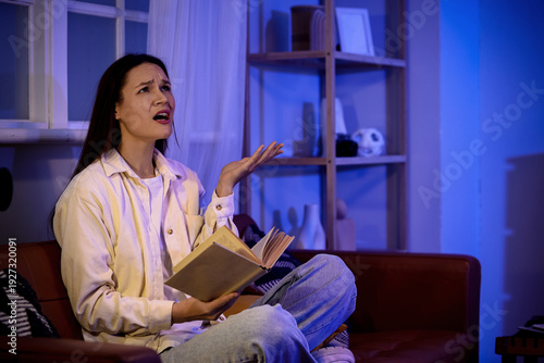 Young woman with book suffe...