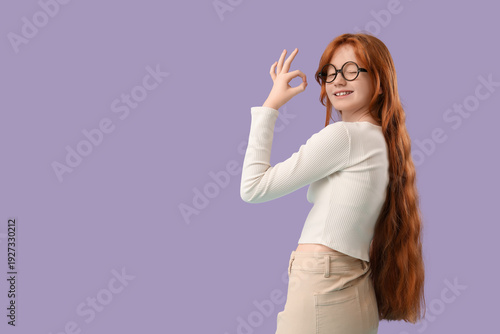 Teenage redhead girl showin...