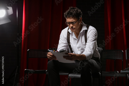 Male screenwriter reading s...