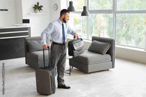 Young businessman with bags...