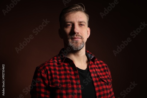 Brutal man with beard on dark background
