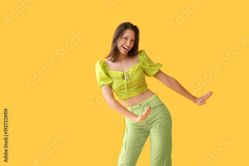 Happy young woman dancing o...