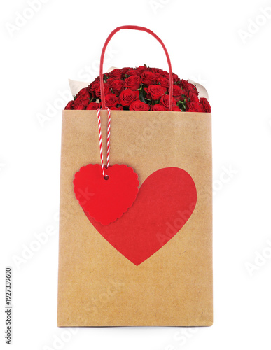 Bouquet of red roses in paper bag with red heart on white background. Romanti...