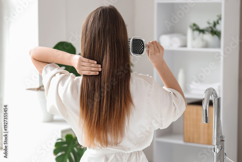 Beautiful young woman brush...