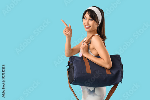 Young woman with sports bag...