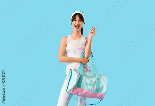 Young woman with sports bag...