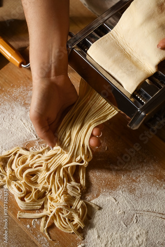 Young woman making pasta wi...
