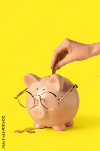 Female hand putting coin in...
