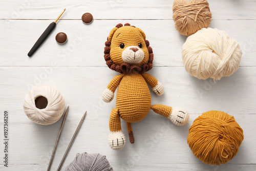 Knitted lion toy with yarn,...