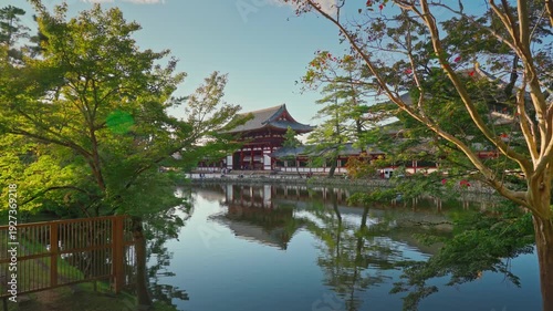 Nara, Japan - Sep 26 2024, 4k, Panoramic view across the pond and trees to the facade of Todaiji Temple, Great Buddha Hall, with a blue cloudy sky, Nara, Japan