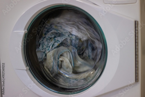 Wallpaper Mural Laundry spinning inside washing machine during wash cycle Torontodigital.ca